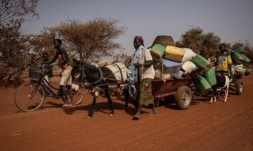 People with their belongings piled on a makeshift trailer pulled by a donkey flee their villages, on the road from Barsalogho to Kaya on January 27, 2020. - Barsalogho is a small town in northern Burkina Faso that hosts 10,000 displaced persons and refugees fleeing the resulting jihadist and inter-community violence.  
Burkina Faso, which borders Mali and Niger, is facing jihadist attacks, which have killed more than 750 people since 2015. Under-equipped and poorly trained law enforcement agencies in Burkina Faso are unable to stop the spiral of violence. According to the United Nations, jihadist attacks in Mali, Niger and Burkina have resulted in 4,000 deaths in 2019. (Photo by OLYMPIA DE MAISMONT / AFP)