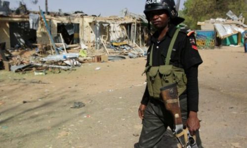 A police officer walks past the ruins of a market outside the state police headquarters in Kano, Nigeria, on Tuesday, Jan. 24, 2012. Police said Tuesday that members of the radical Islamist group Boko Haram dressed in uniforms resembling those of soldiers and police officers when they launched their attack Friday in Kano. At least 185 people (AP Photo/Sunday Alamba)