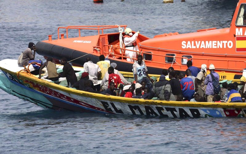 epa01155568 A sea rescue ship tows a small boat with 105 Sub Saharan illegal immigrants on board towards Arona port in Tenerife island, the Canaries, Spain, 24 October 2007. The immigrant's boat was sighted 30 miles from the island.  EPA/MANUEL LERIDA